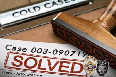 A graphic illustration titled Cold Cases with a large wooden stamp on a wooden desk that reads "Case Solved" with stamped case files next to it. The Gresham Police Department badges are set in the right-hand corner.