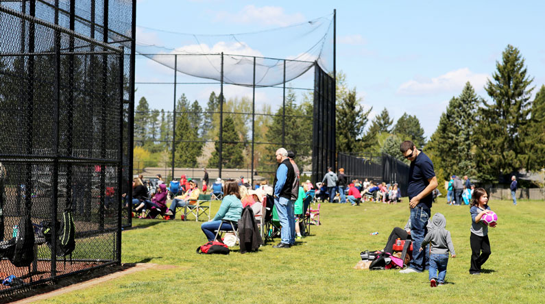 Crowds gather at Gradin Sports Park to watch softball games.